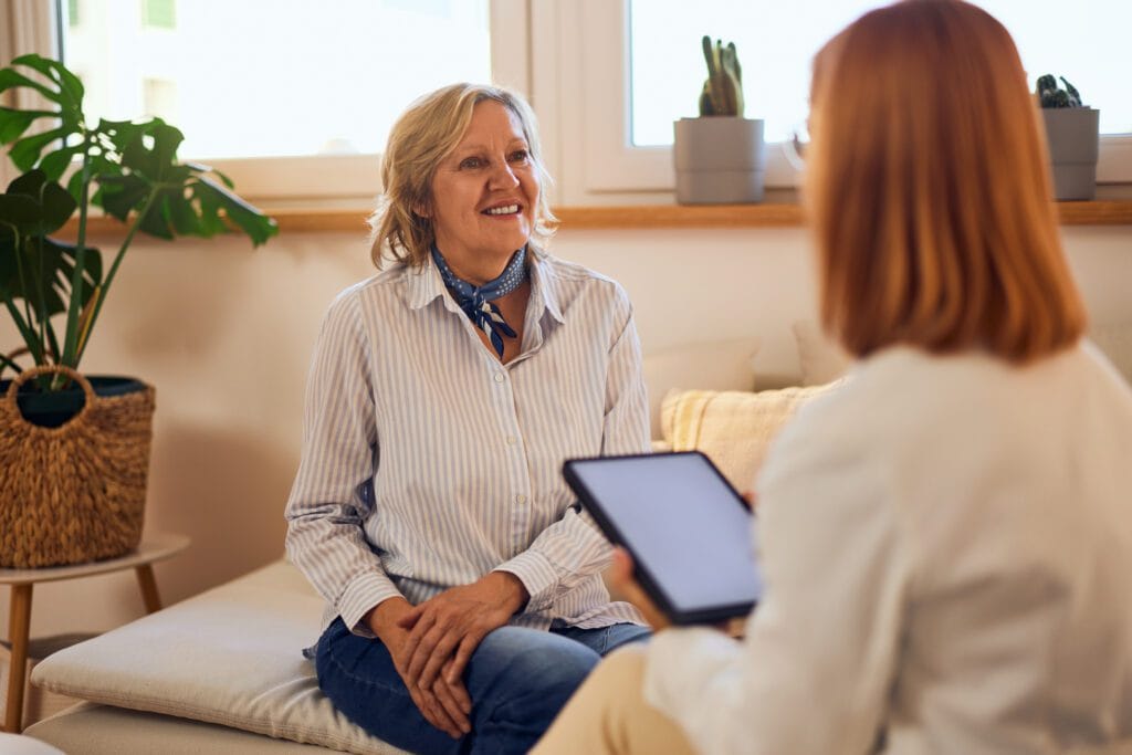 a smiling female patient talking to a female thera 2025 09 09 20 04 59 utc